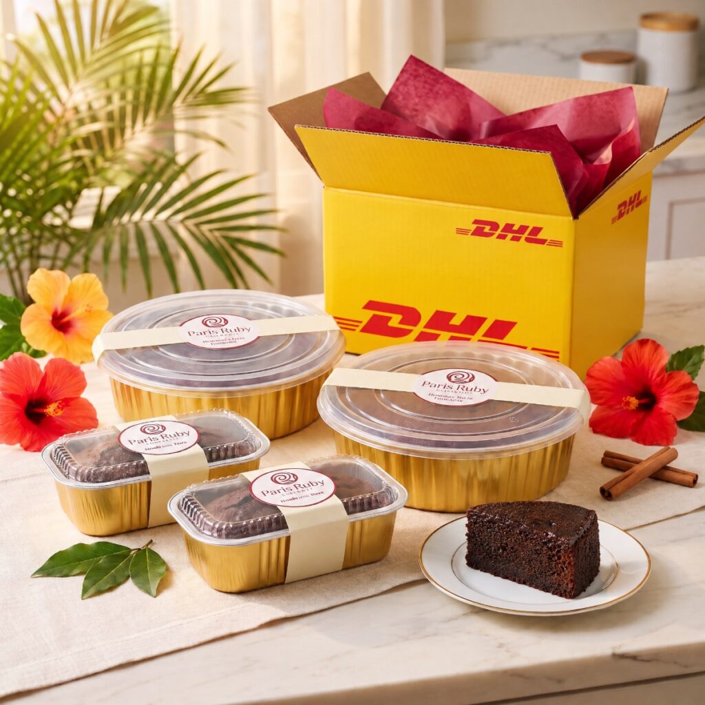 Two 1 lb Paris Ruby fruitcakes and two half-pound minis in gold pans beside an open yellow DHL Express box