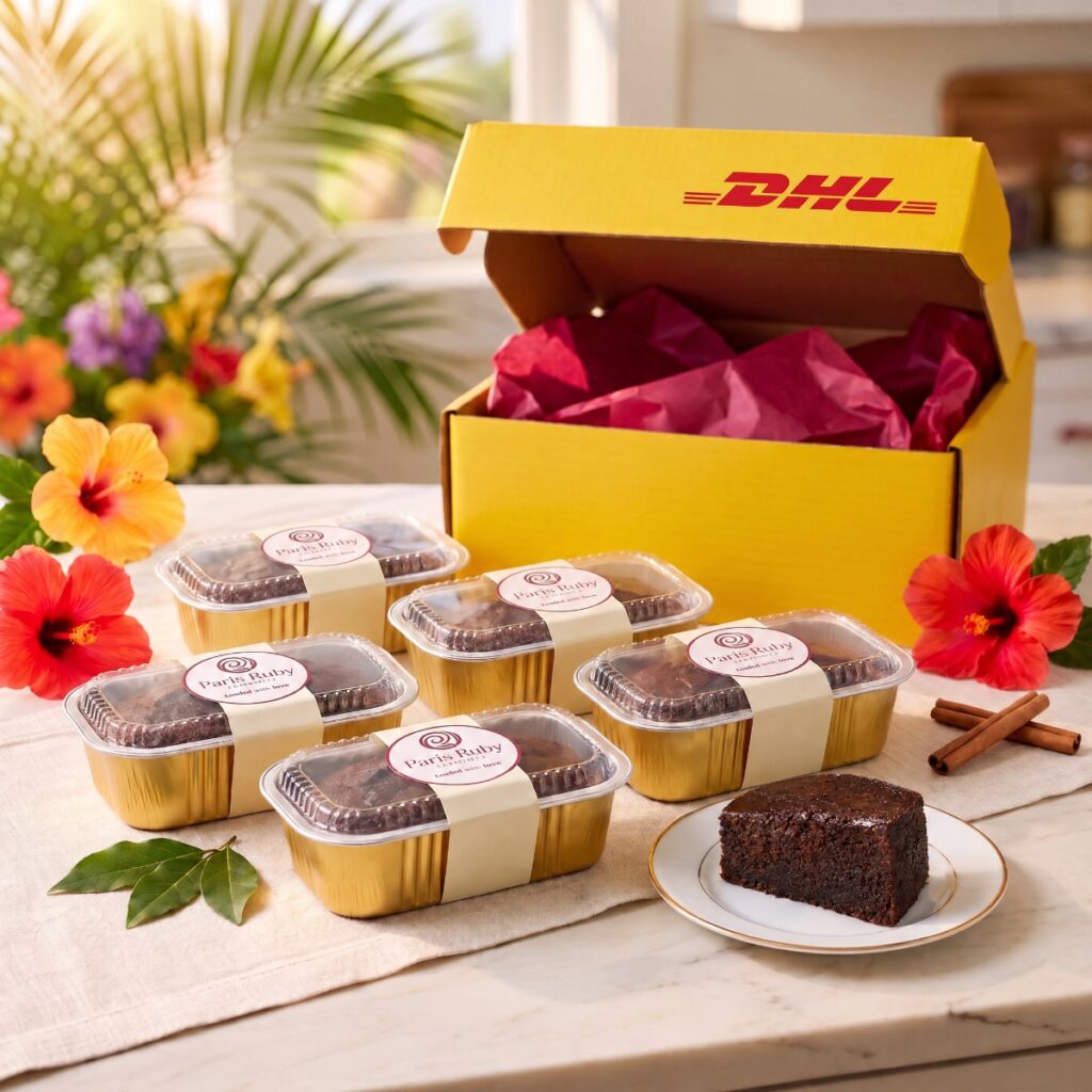 Six half-pound Paris Ruby mini fruitcakes in gold pans beside an open yellow DHL Express box