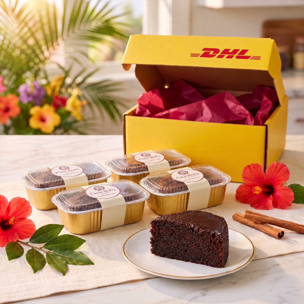 Four half-pound Paris Ruby mini fruitcakes in gold pans beside an open yellow DHL Express box